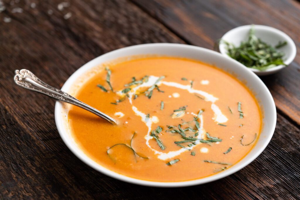 A Tomato Soup Bowl With a White Cream Heart