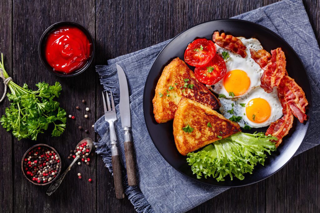 Irish breakfast of fried eggs on a black plate