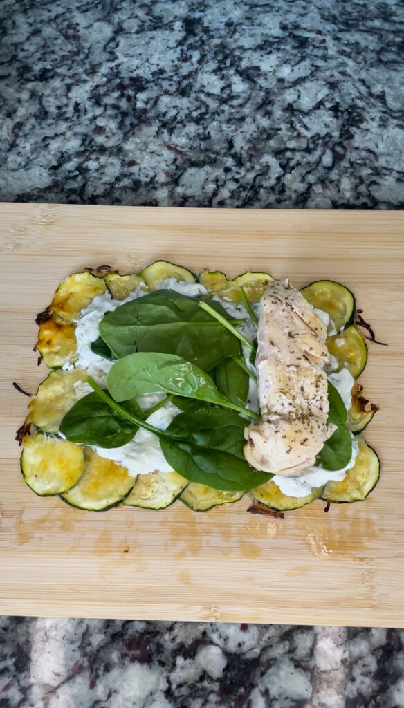 Zucchini wrap with tzatziki sauce, spinach, and chicken