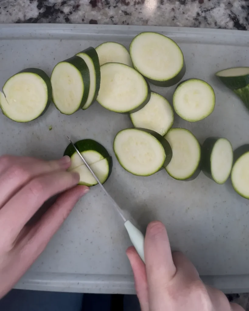 Cutting Zucchini on a cutting board