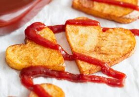 Preparing a food for Valentine's Day abstract love concept witch french fries chips heart shape