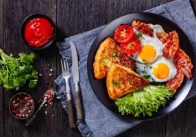 Irish breakfast of fried eggs on a black plate