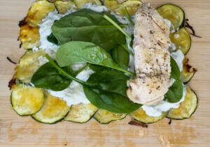 Zucchini wrap with tzatziki sauce, spinach, and chicken