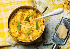 A Bowl of Pasta With Yellow Color Sauce